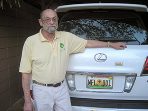 Gary Henry and car with State Wildflower license plate