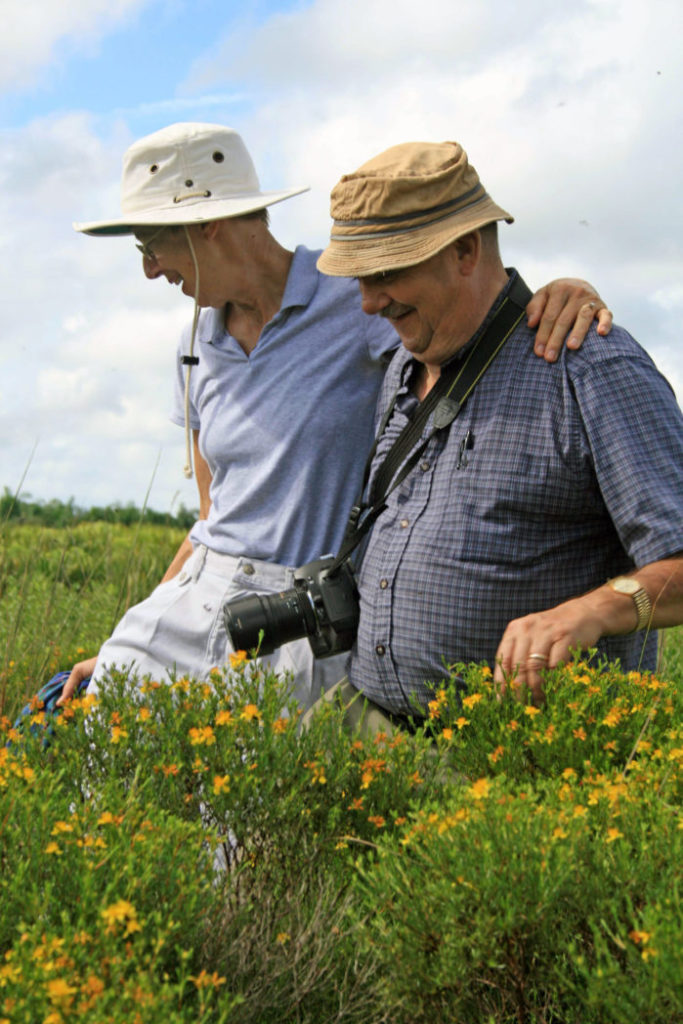 Karin and Walter Taylor walking in field of flowers