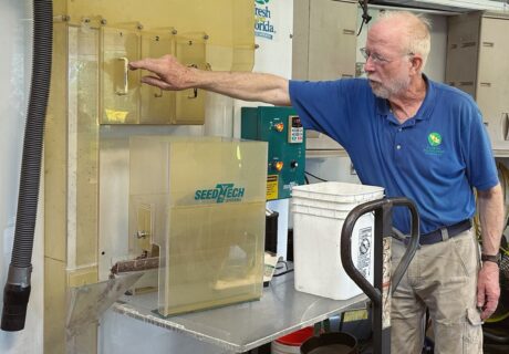 Terry Zinn operating seed sorting equipment.