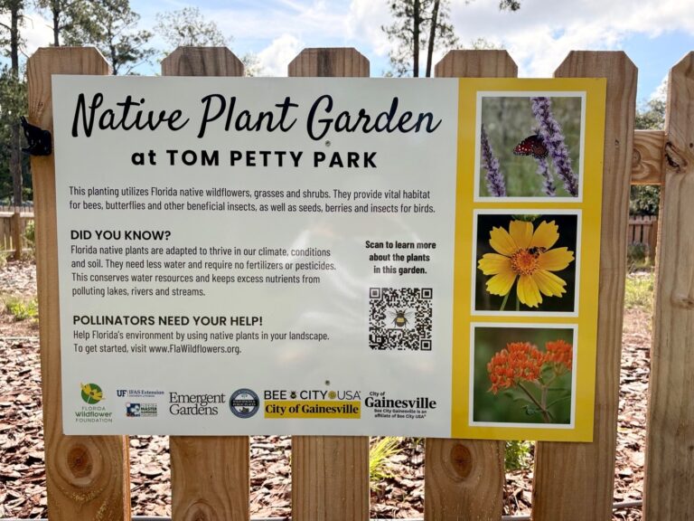 Sign about the Native Plant Garden at Tom Petty Park, describing its role in supporting pollinators, with plant photos, logos, and a QR code for more information.